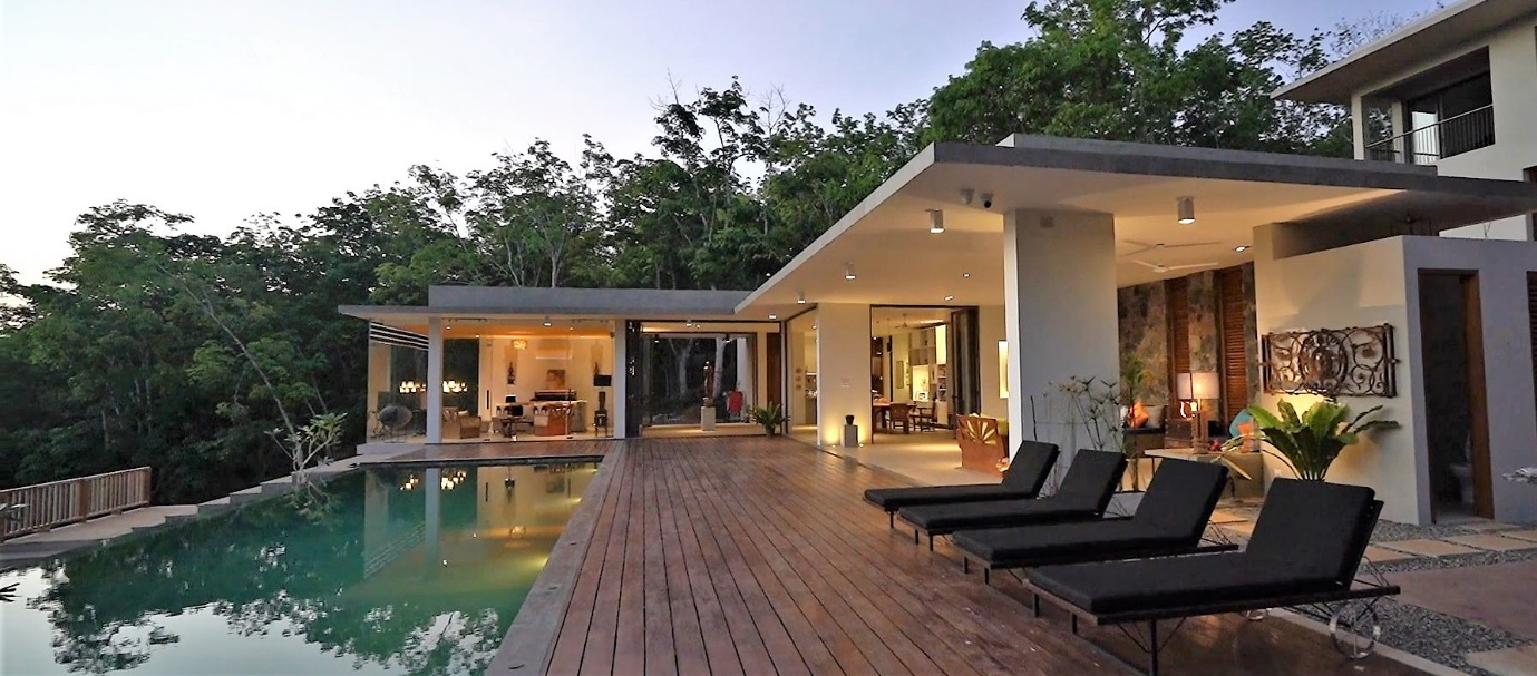 Luxury villa at dusk with infinity pool